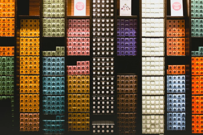 a wall of different colored boxes on display